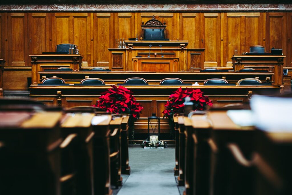 pexels-photo-14766052-14766052 Spacious and elegant wooden courtroom with empty seats, located in Bern, Switzerland.